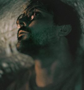 a man laying in bed with his eyes closed